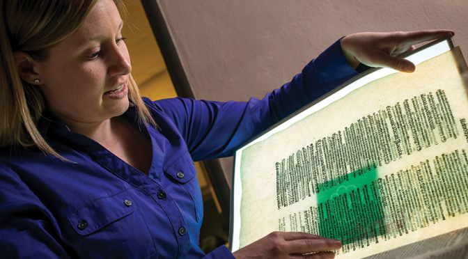 woman looking at antique script